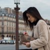 Femme avec un manteau beige a Paris qui porte une pochette en strass mordoré pour le petit je ne sais quoi